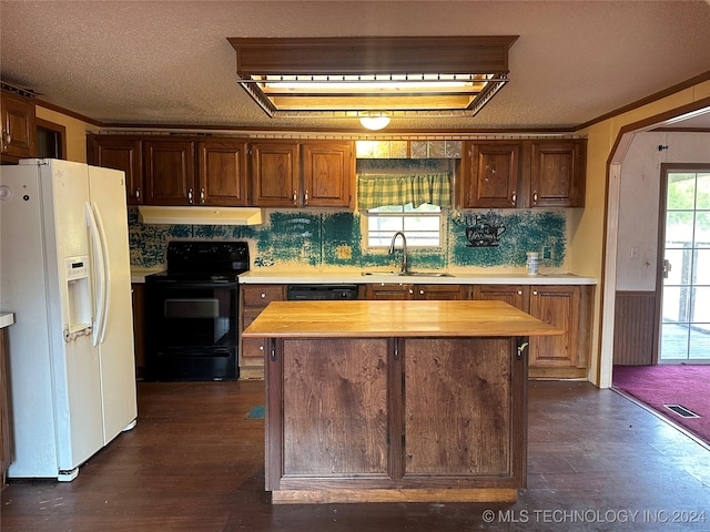 kitchen with dark wood-type flooring, wood counters, black appliances, and a center island