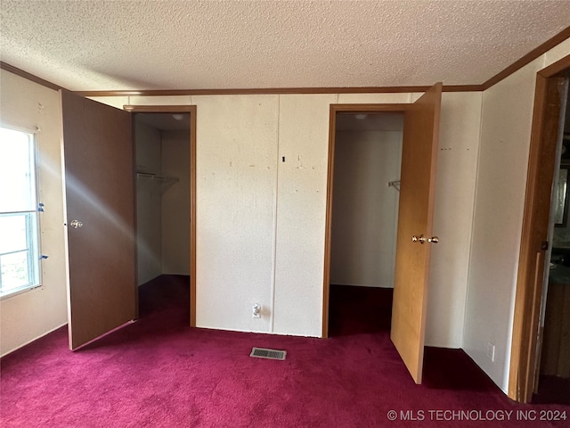 unfurnished bedroom featuring a textured ceiling and carpet floors