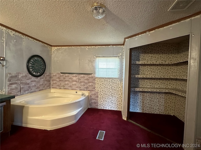 bathroom with a bathtub and a textured ceiling