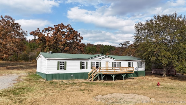 view of front of property featuring a front yard and a wooden deck