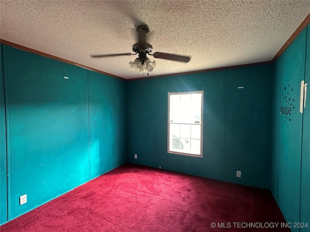 spare room with carpet, ceiling fan, and a textured ceiling