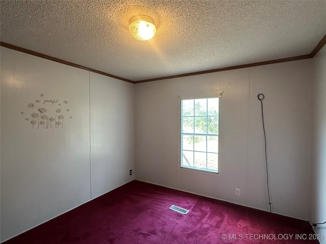 carpeted spare room featuring crown molding and a textured ceiling