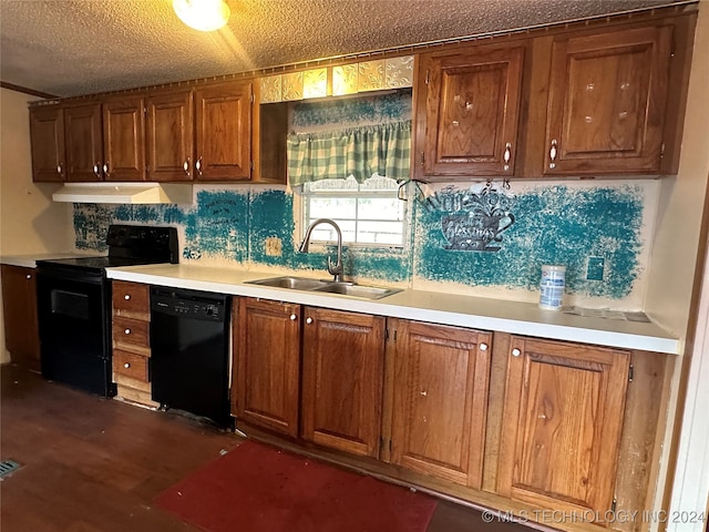 kitchen with dark wood-type flooring, backsplash, sink, black appliances, and a textured ceiling