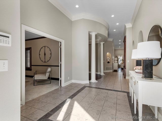 hall featuring ornamental molding, light tile patterned floors, and decorative columns