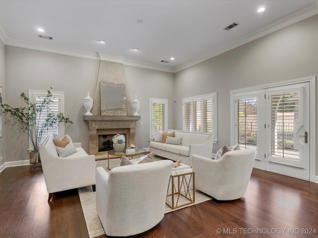 living room featuring a large fireplace, crown molding, a high ceiling, and dark hardwood / wood-style floors