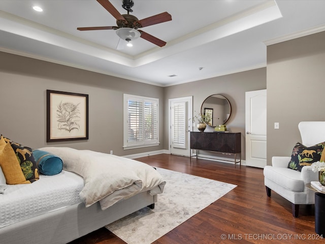 bedroom featuring crown molding, a raised ceiling, ceiling fan, and dark hardwood / wood-style flooring