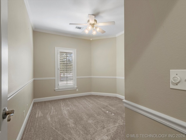 spare room with ornamental molding, carpet flooring, and ceiling fan