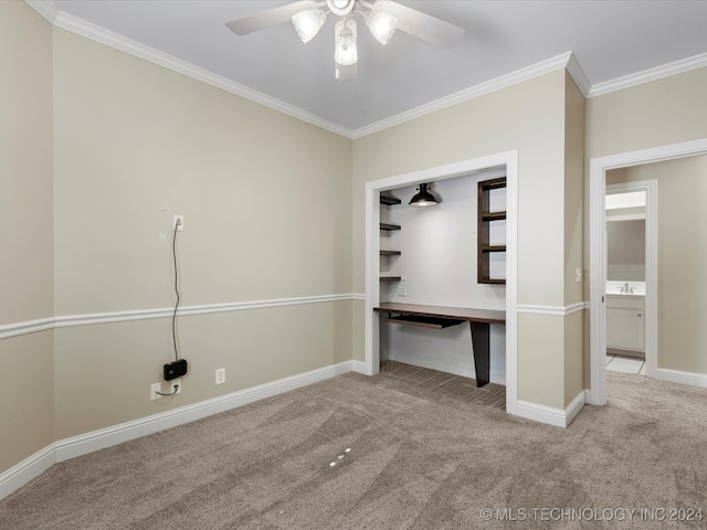 unfurnished bedroom featuring ceiling fan, crown molding, carpet, and sink