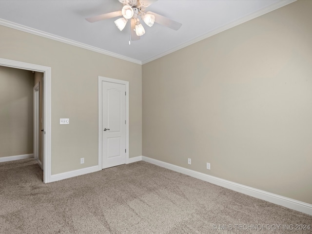 unfurnished bedroom with ornamental molding, carpet floors, and ceiling fan