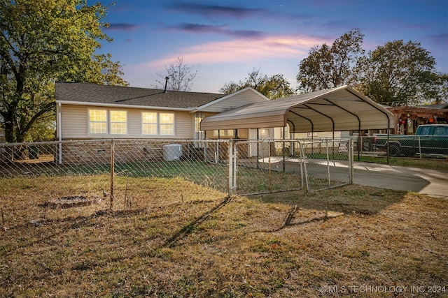 exterior space featuring a lawn and a carport