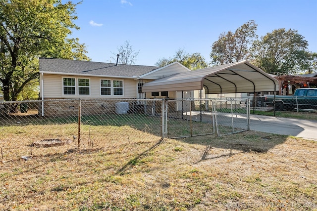 back of house with a yard and a carport