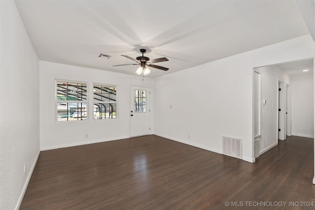 spare room featuring ceiling fan and dark hardwood / wood-style flooring