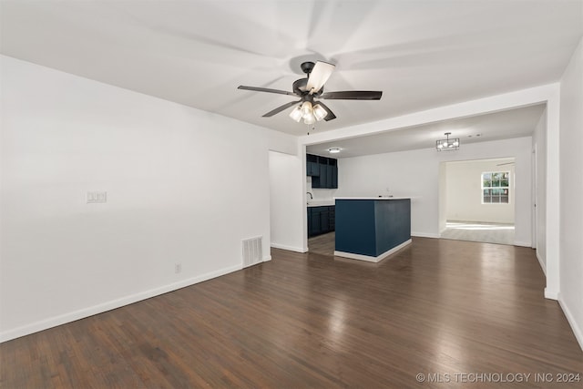 unfurnished living room featuring dark hardwood / wood-style floors, sink, and ceiling fan