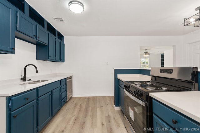 kitchen with sink, light wood-type flooring, ceiling fan with notable chandelier, stainless steel appliances, and blue cabinetry