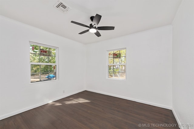 empty room with ornamental molding, dark hardwood / wood-style floors, and ceiling fan