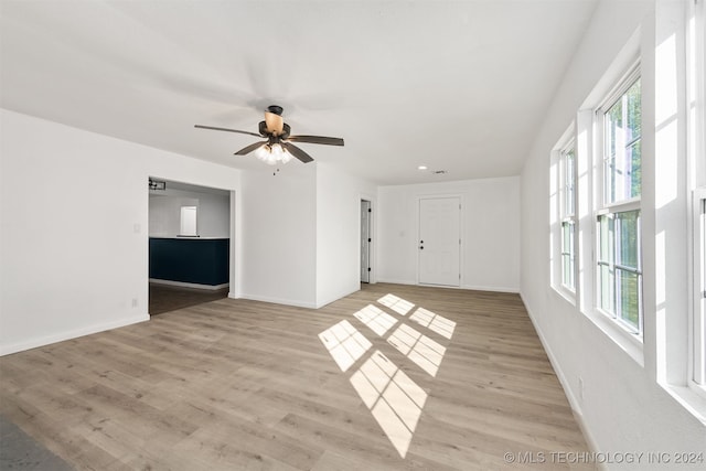 unfurnished room with ceiling fan and light hardwood / wood-style flooring