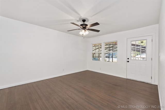 empty room featuring dark wood-type flooring and ceiling fan