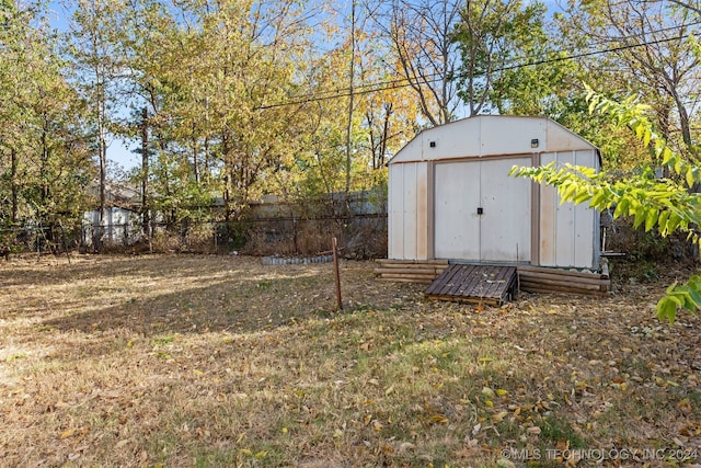 view of outbuilding with a yard