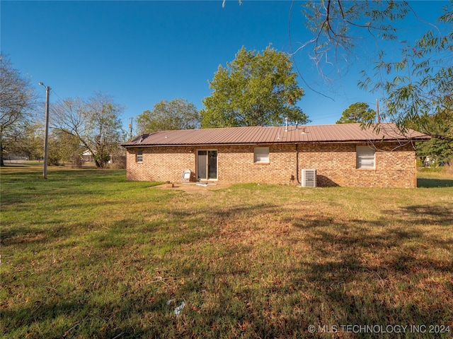 rear view of house with a yard