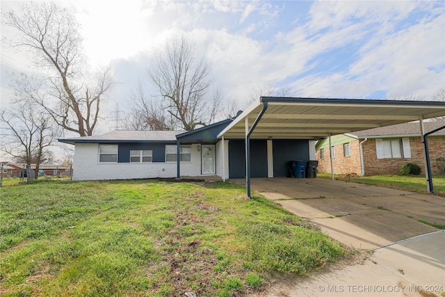 ranch-style home featuring a front yard and a carport