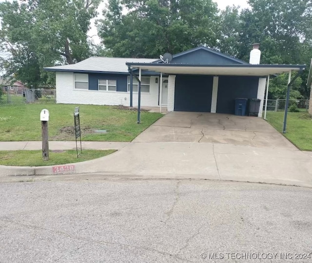 ranch-style house featuring a front yard and a carport