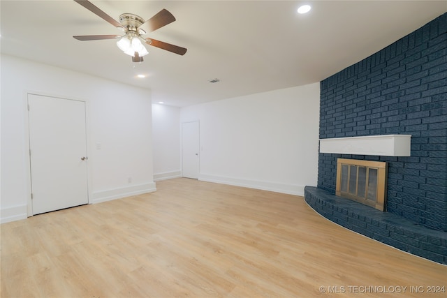 unfurnished living room with light hardwood / wood-style flooring, a fireplace, and ceiling fan