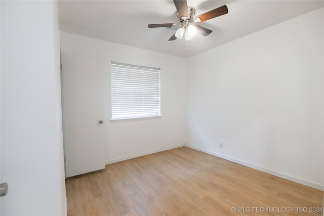 empty room with light hardwood / wood-style flooring and ceiling fan