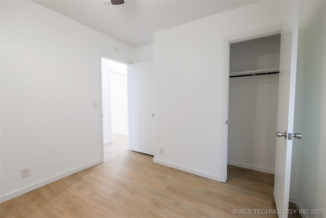 unfurnished bedroom featuring a closet and light hardwood / wood-style flooring