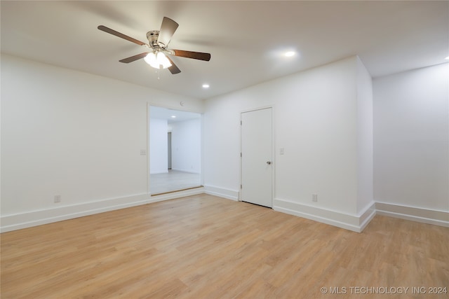 spare room with light hardwood / wood-style floors and ceiling fan