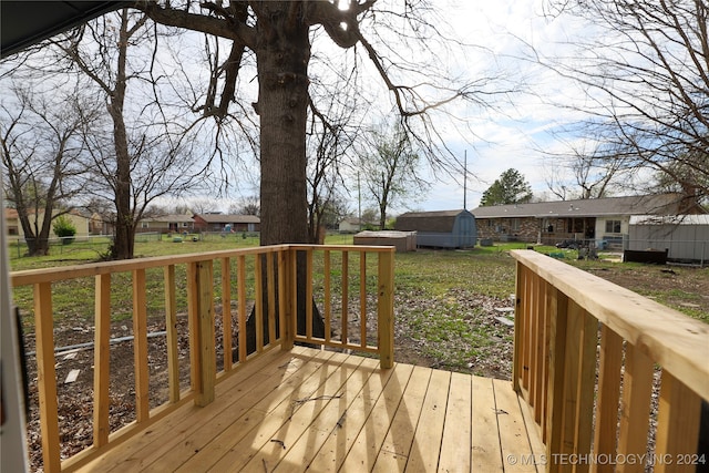 wooden terrace with a yard