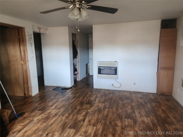 interior space with heating unit, ceiling fan, and dark wood-type flooring