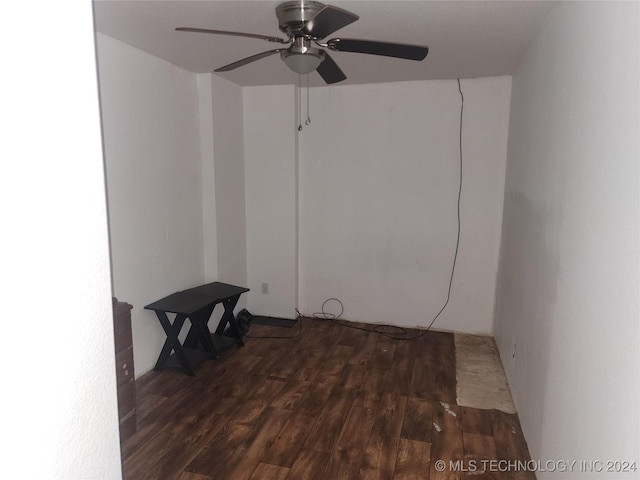 spare room featuring dark hardwood / wood-style flooring and ceiling fan