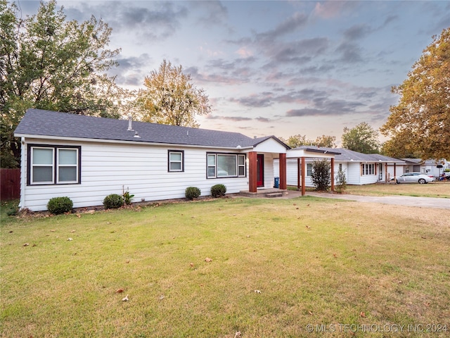 ranch-style home with a yard