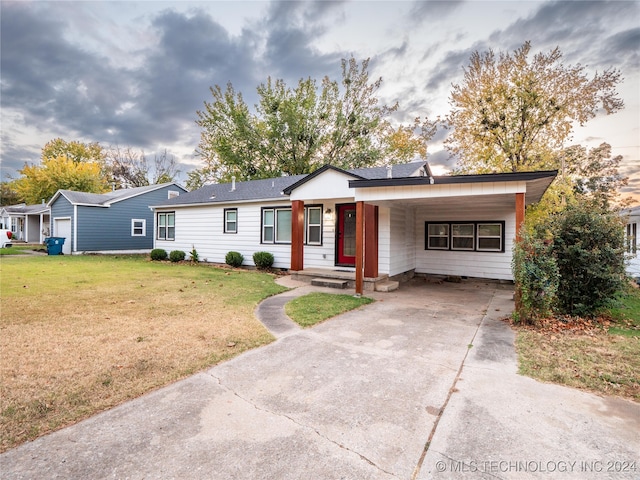 single story home featuring a front yard and a carport