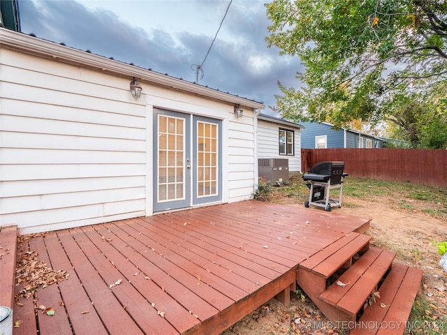 wooden terrace featuring central AC and a grill