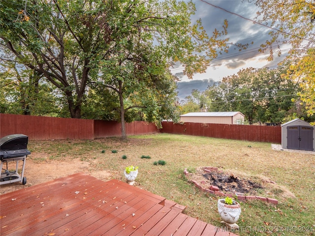 view of yard with a shed and a deck