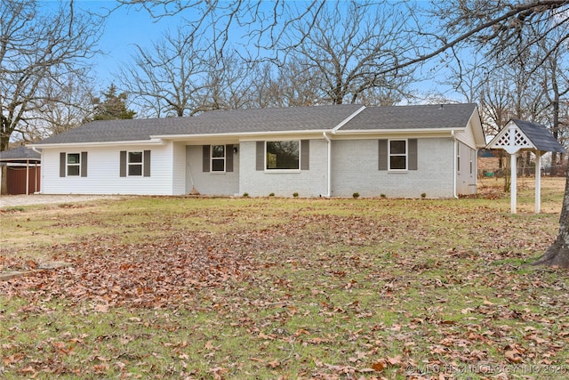 single story home featuring a front lawn