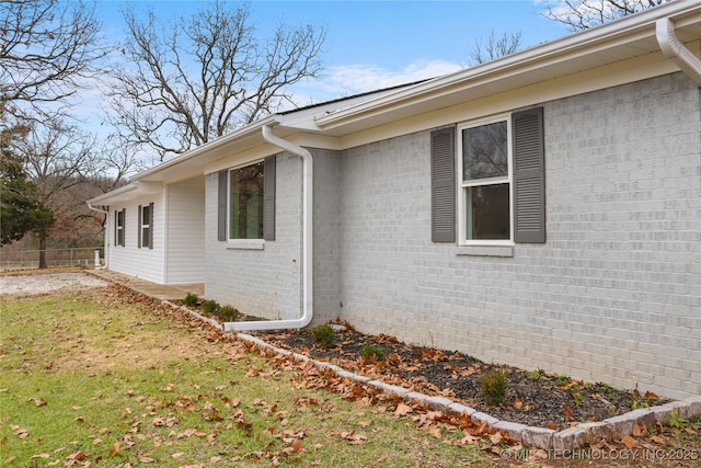 view of side of home featuring a yard