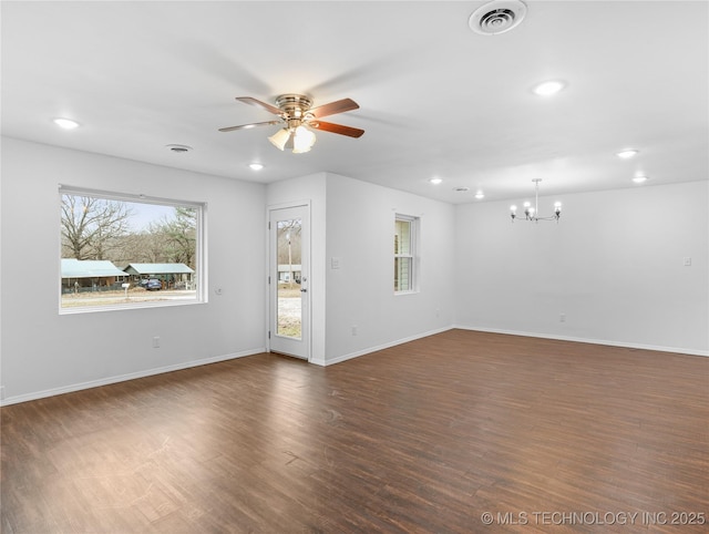 unfurnished living room featuring dark hardwood / wood-style flooring and ceiling fan with notable chandelier