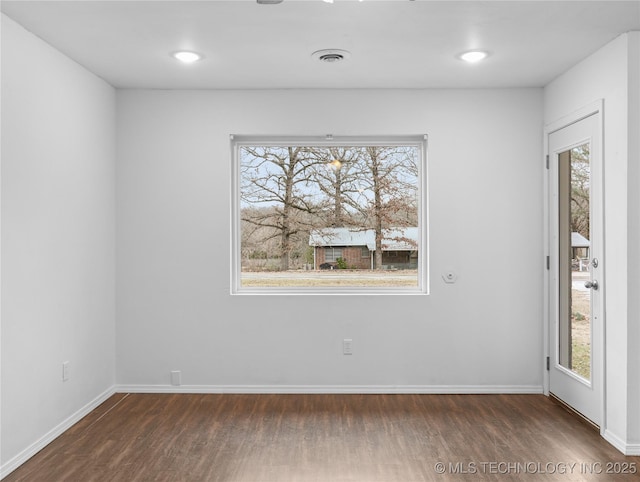 unfurnished room with dark hardwood / wood-style flooring