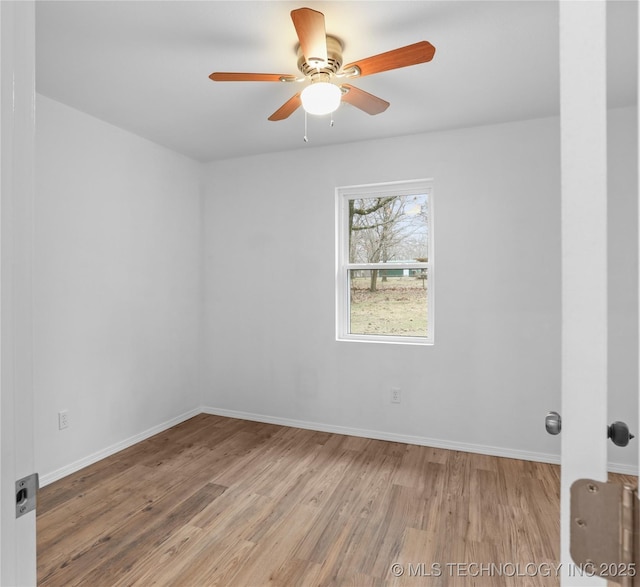 empty room featuring ceiling fan and hardwood / wood-style flooring