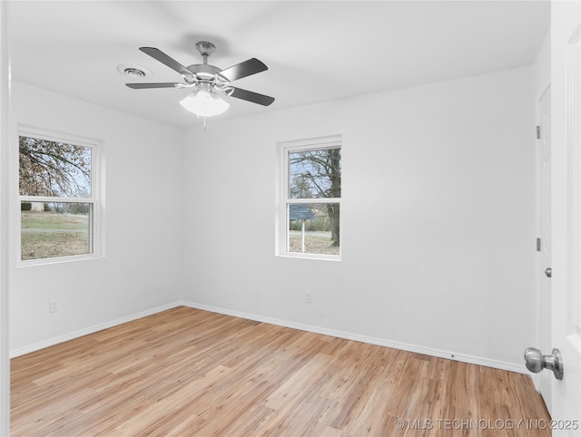 spare room featuring light wood-type flooring and ceiling fan