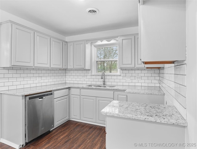 kitchen with backsplash, gray cabinets, stainless steel dishwasher, sink, and dark hardwood / wood-style flooring