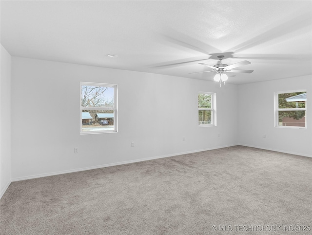 unfurnished room featuring ceiling fan and carpet floors