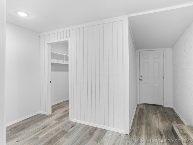 corridor with light hardwood / wood-style floors