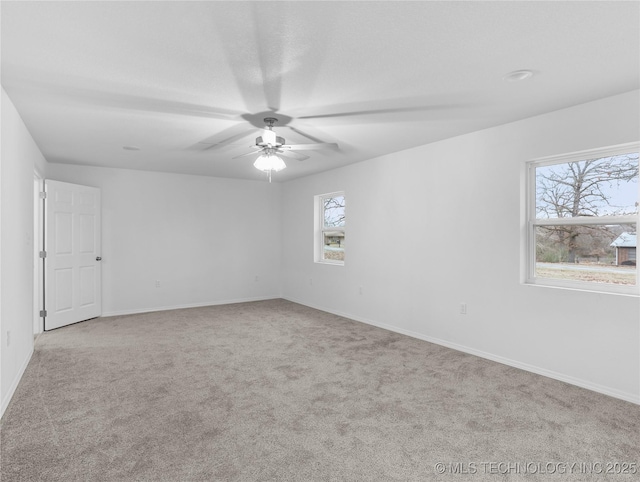 empty room with ceiling fan and light carpet