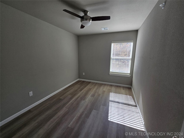 3406 Redbud Ln, Tulsa, OK 74132 - empty room featuring ceiling fan, dark wood finished floors, baseboards, and visible vents