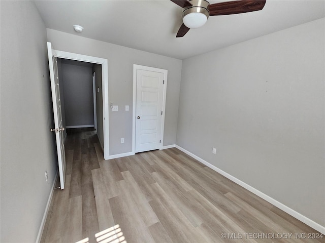 3406 Redbud Ln, Tulsa, OK 74132 - unfurnished bedroom featuring a ceiling fan, baseboards, and light wood-style flooring