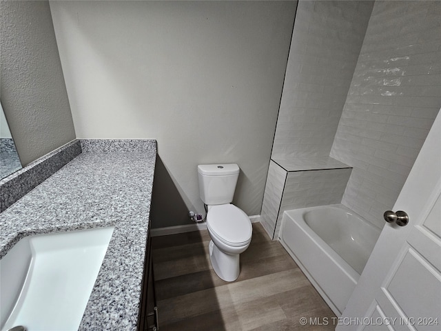 full bathroom featuring vanity, hardwood / wood-style flooring, toilet, and separate shower and tub