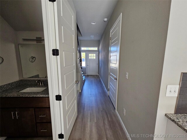 3406 Redbud Ln, Tulsa, OK 74132 - hallway featuring dark wood-type flooring, a sink, and baseboards